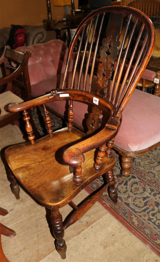 An early 19th century yew and elm hoop back elbow chair